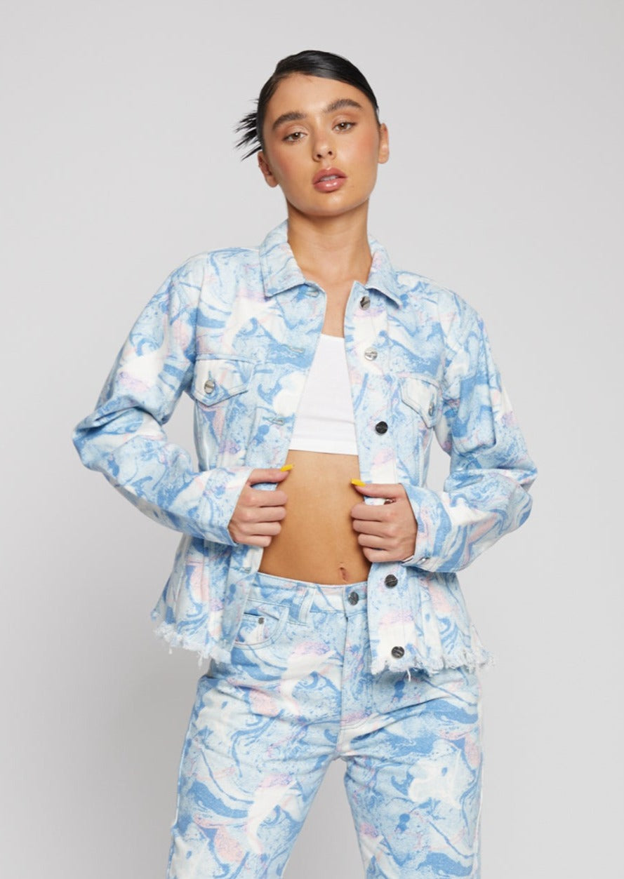 Close-up of a model wearing the women's psychedelic marble print denim jacket.
