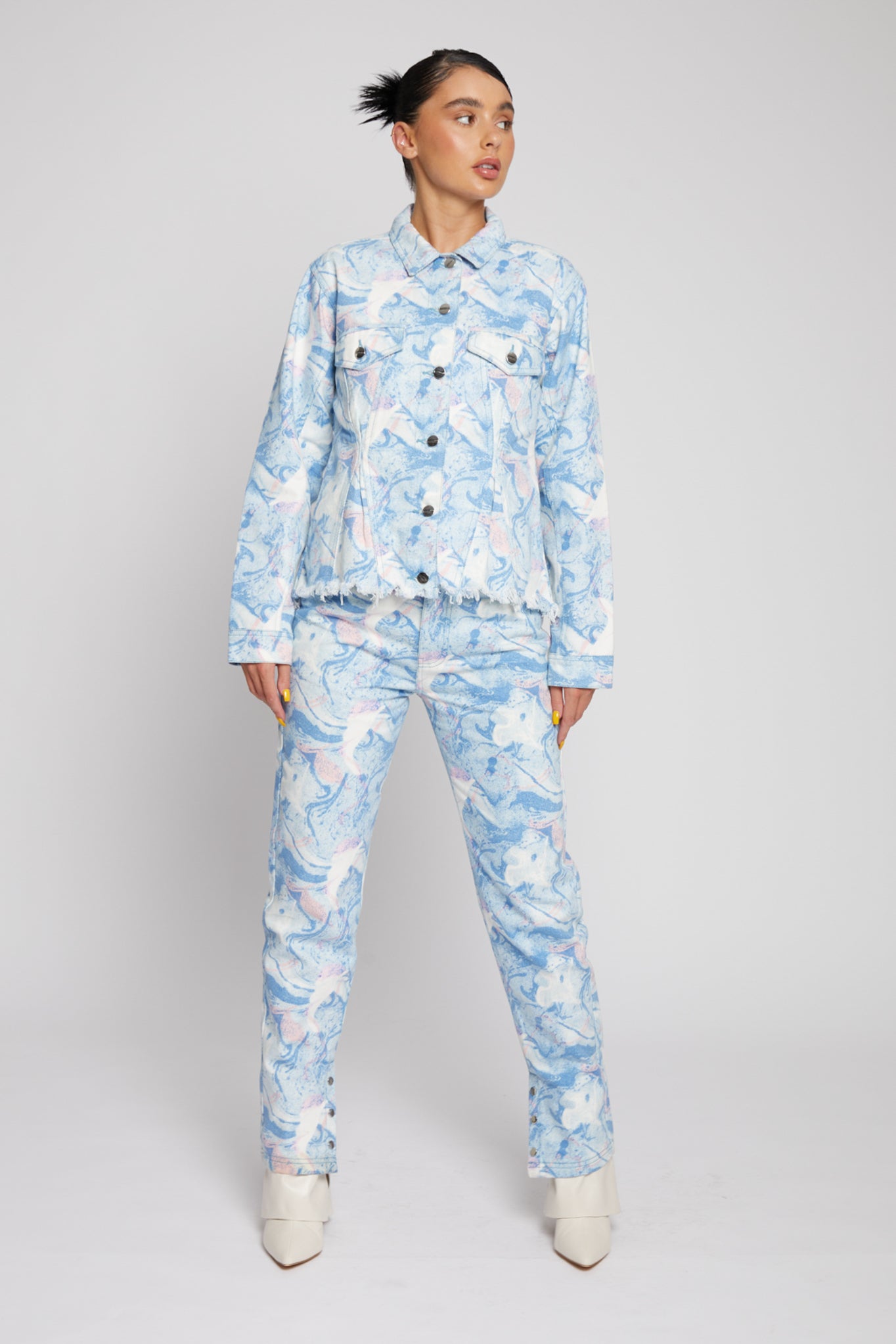 A model styled in the full psychedelic marble print denim jacket and matching jeans.