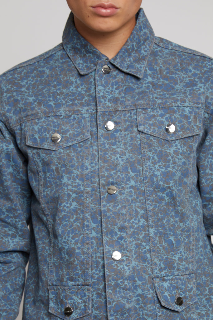 Close-up of the collar and button details on the speckled print jacket