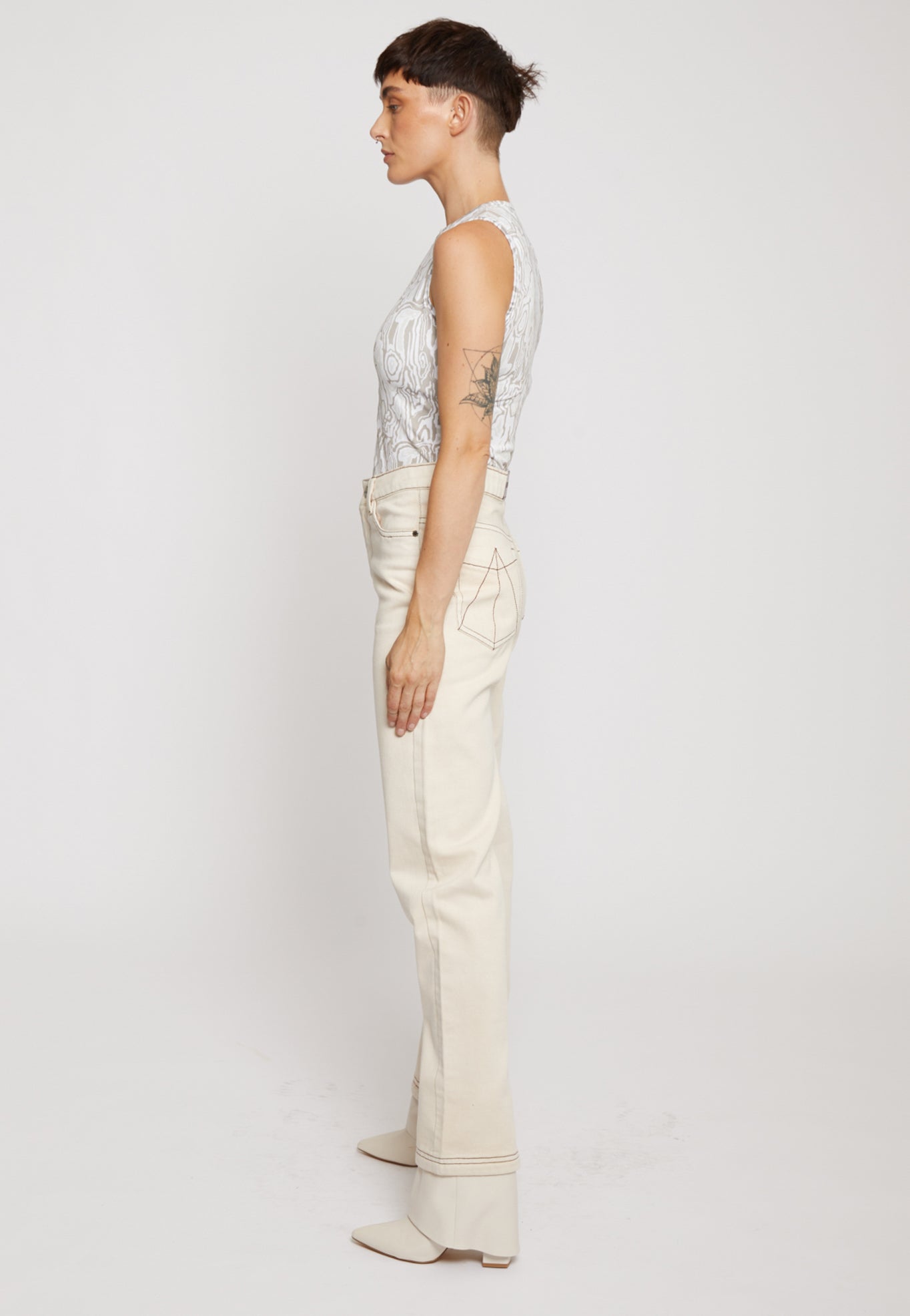 Side profile of the straight leg ecru jeans