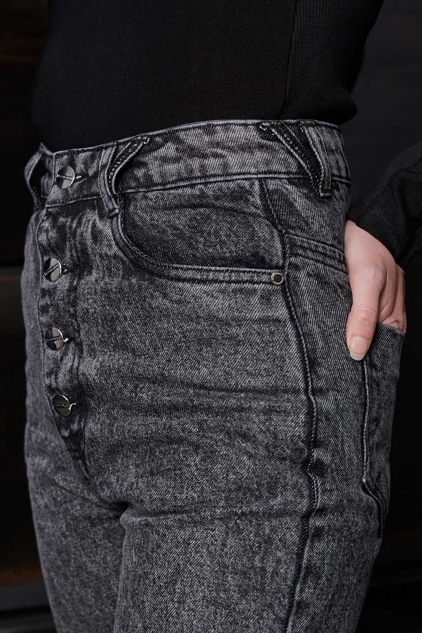 Close-up on the super distressed ripped detail on the grey mom jeans