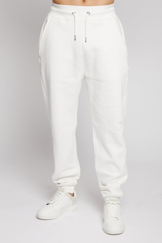 A model wearing the tapered fit joggers for men in white.
