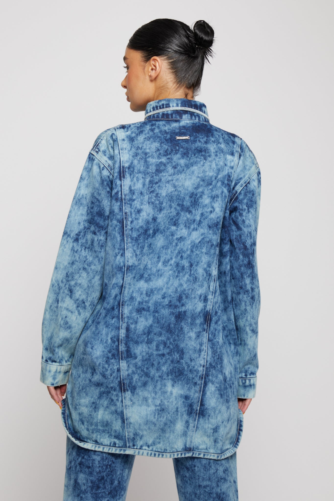 Close-up of the back of the women's bleach wash shirt.