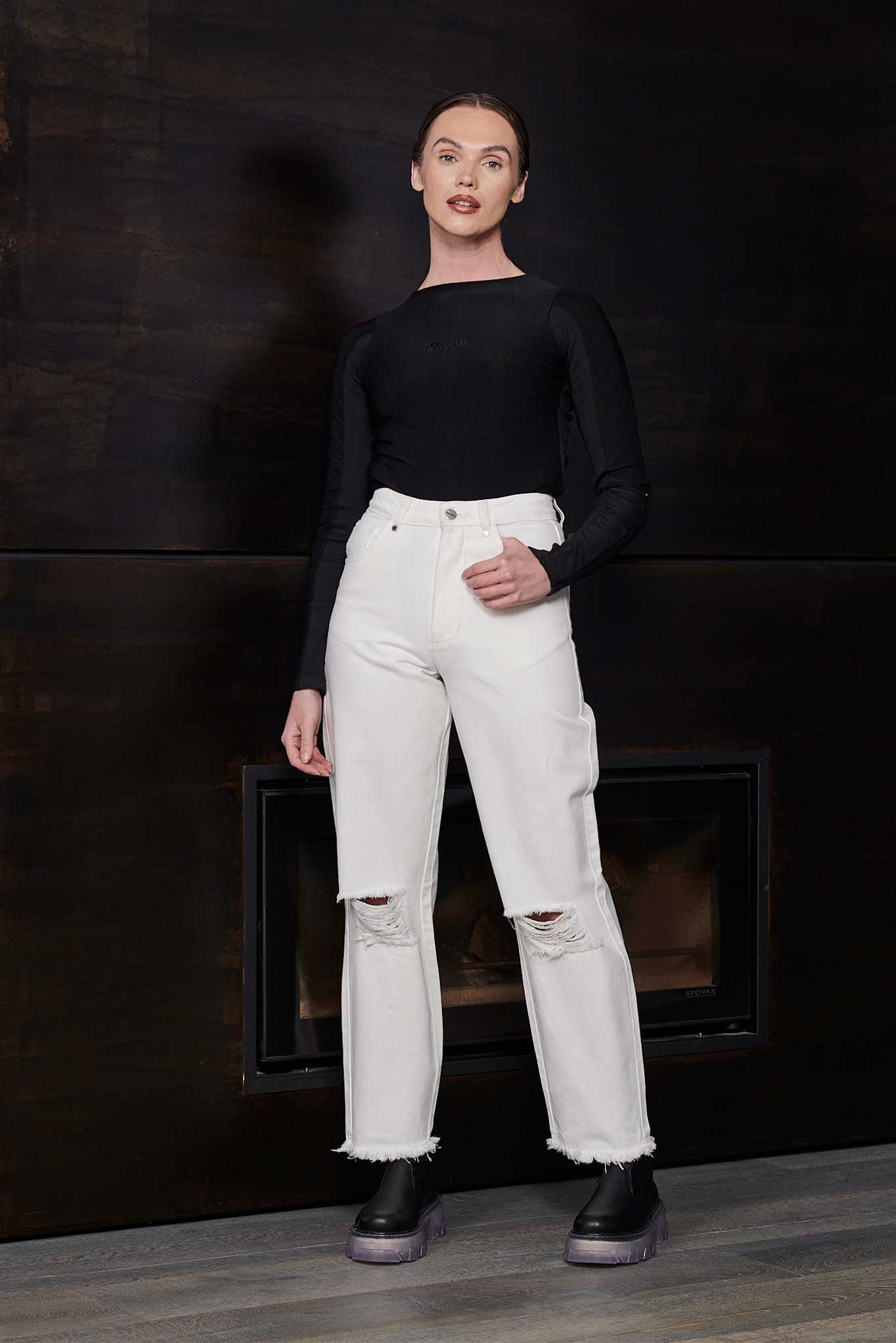 Front view of a model wearing the women's off-white distressed jeans.