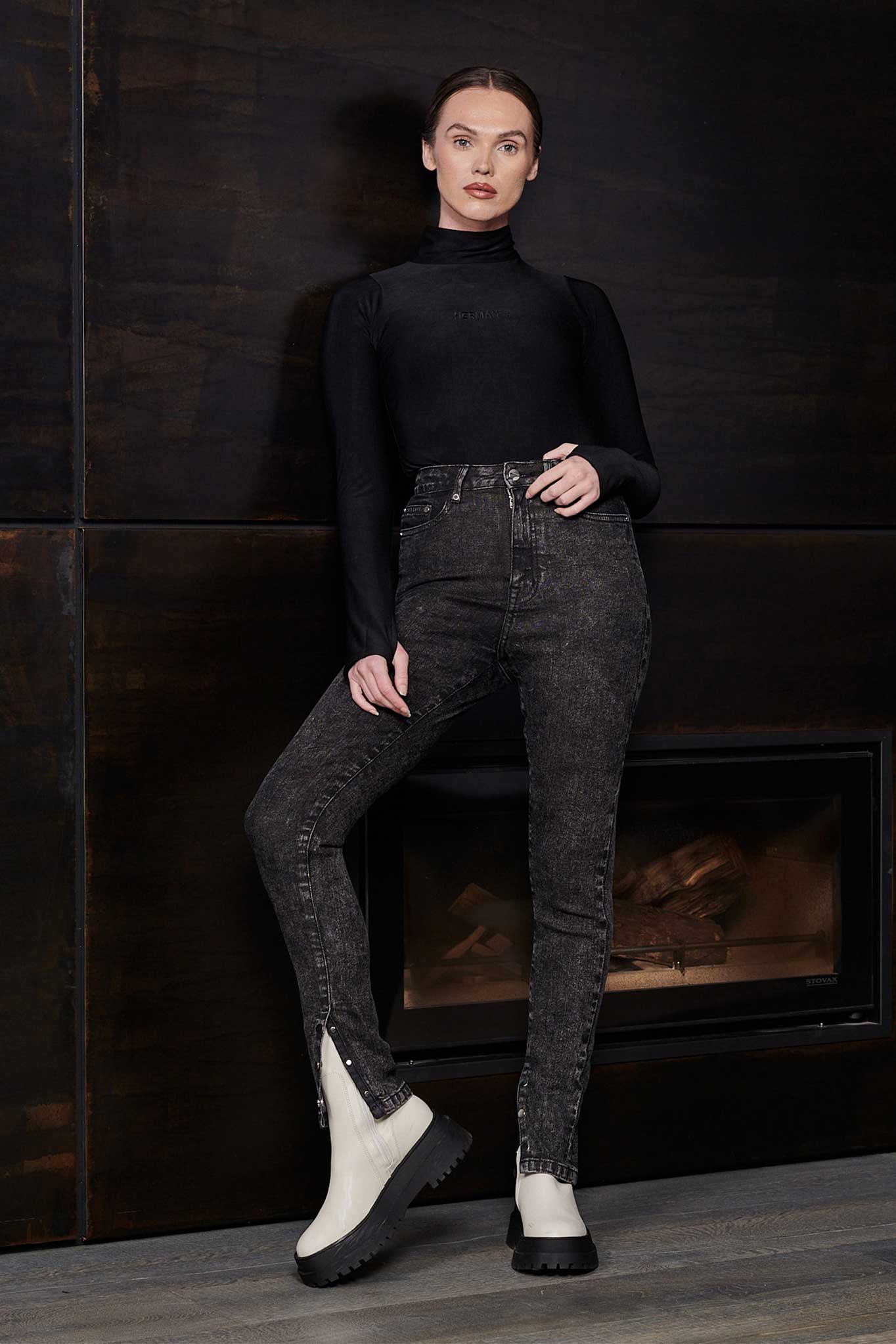 A model wearing high-waisted black acid wash jeans for a complete look