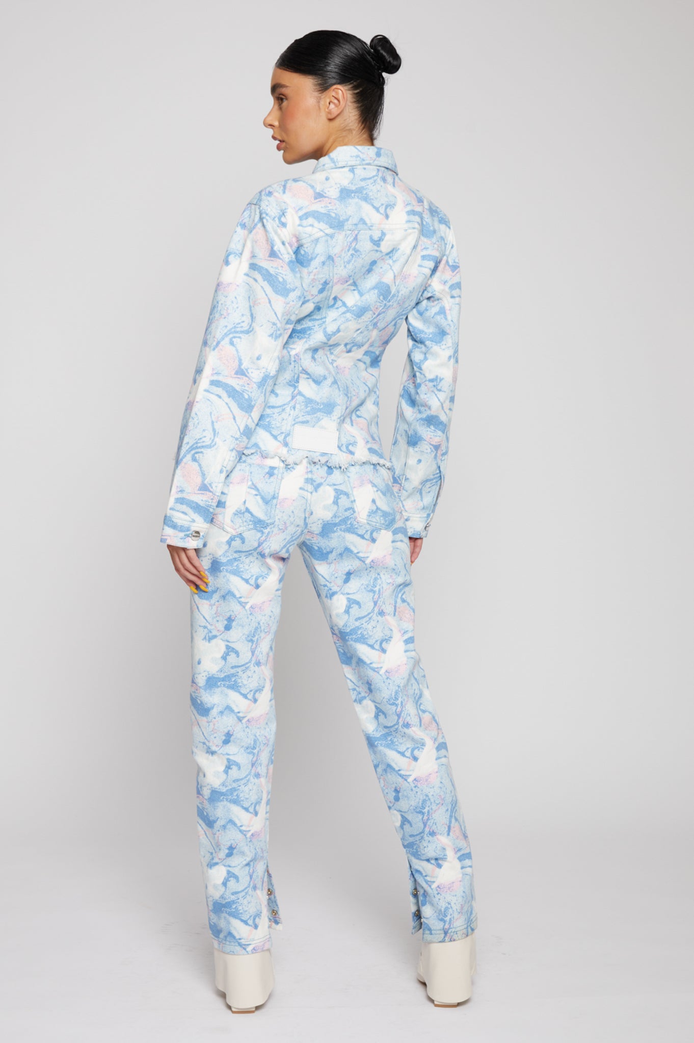 Back view of a model wearing the women's psychedelic denim jacket.