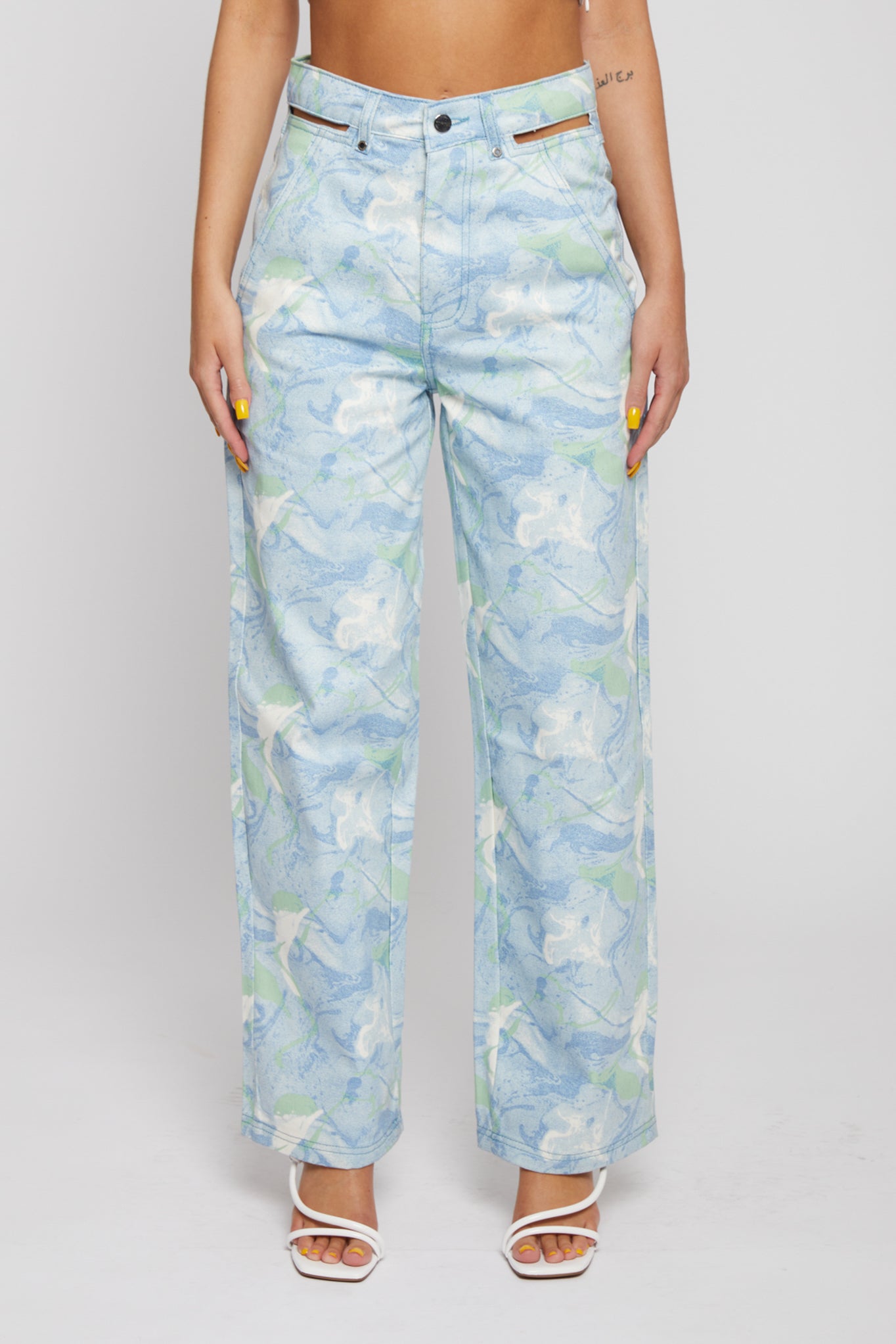 Close-up front view of the women's psychedelic marble print straight leg jeans.