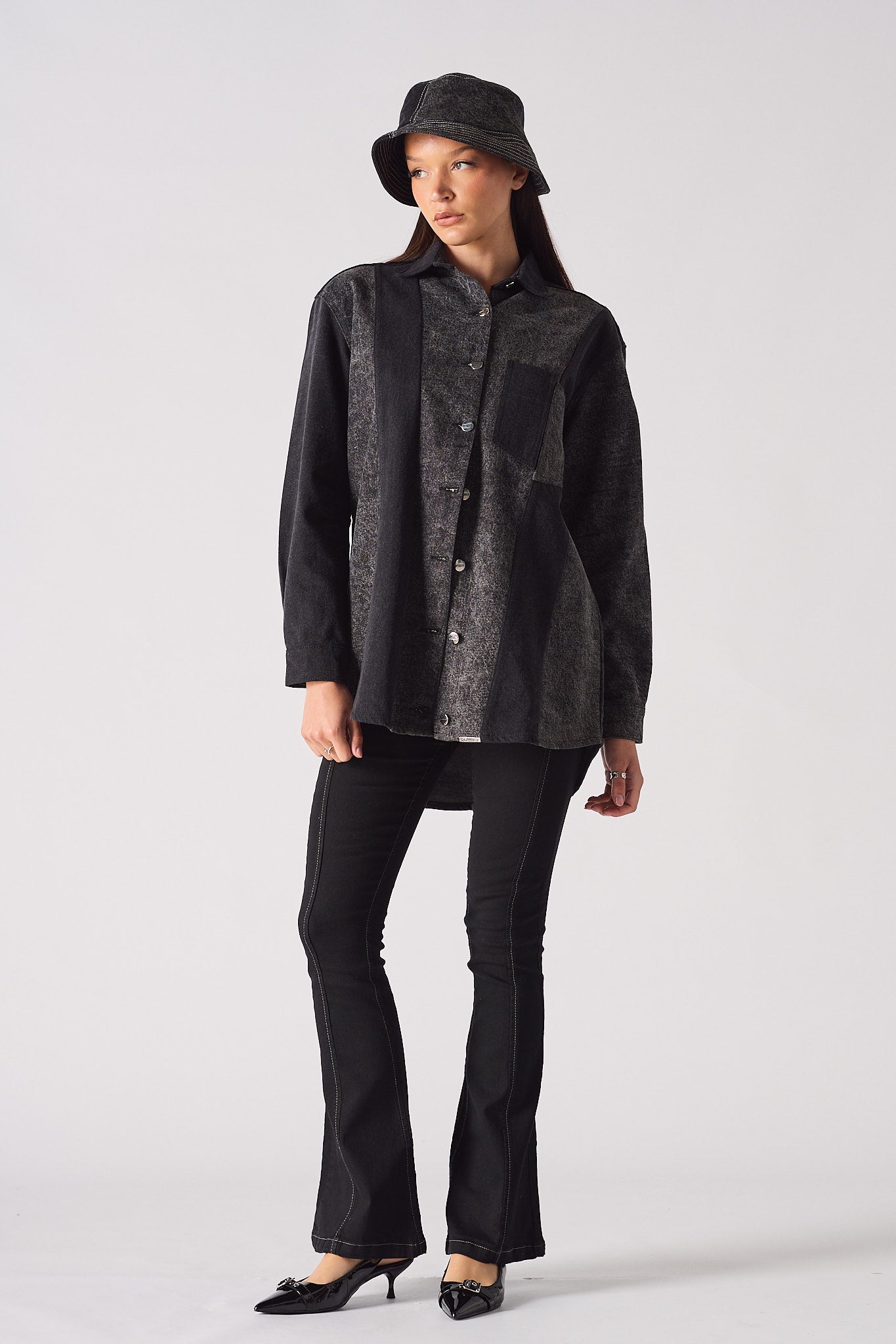 A model styled in the acid wash denim shirt for women with a bucket hat.