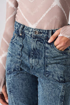 Close-up of the waist and pocket detail on the acid wash mom jeans.