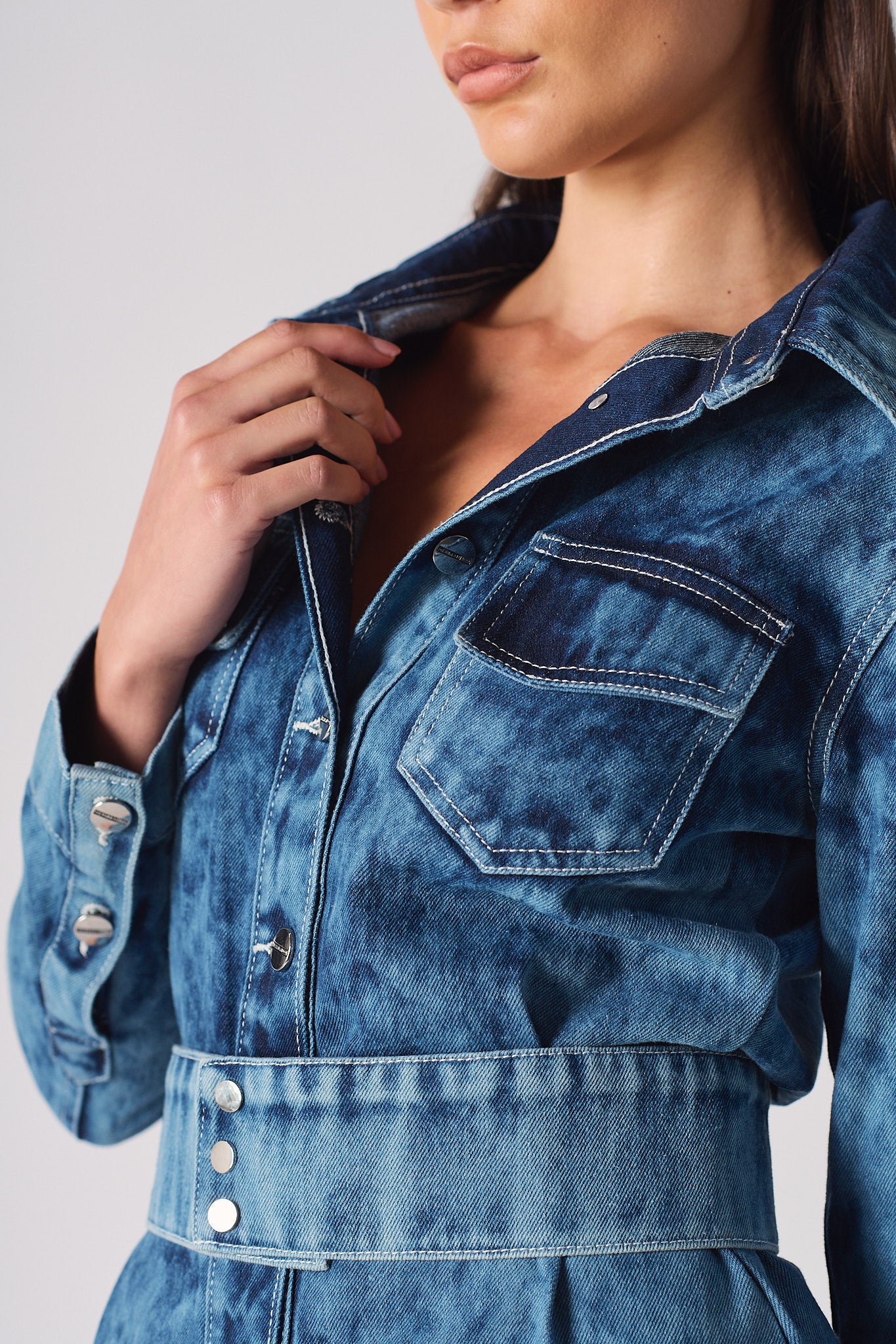 Detailed view of the collar and chest pocket on the acid washed denim dress