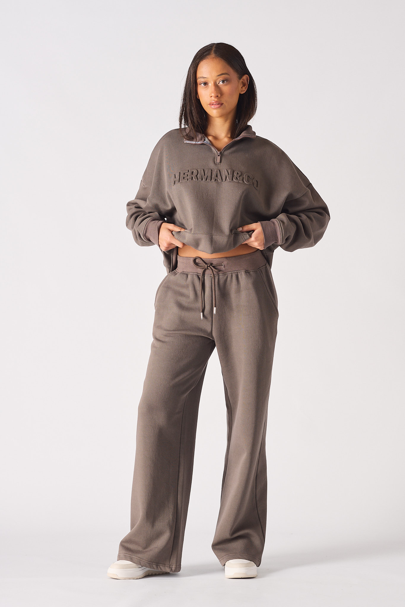 Full front view of a model in the baggy joggers for women in brown.