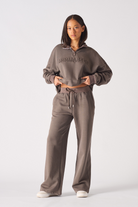 Full front view of a model in the baggy joggers for women in brown.