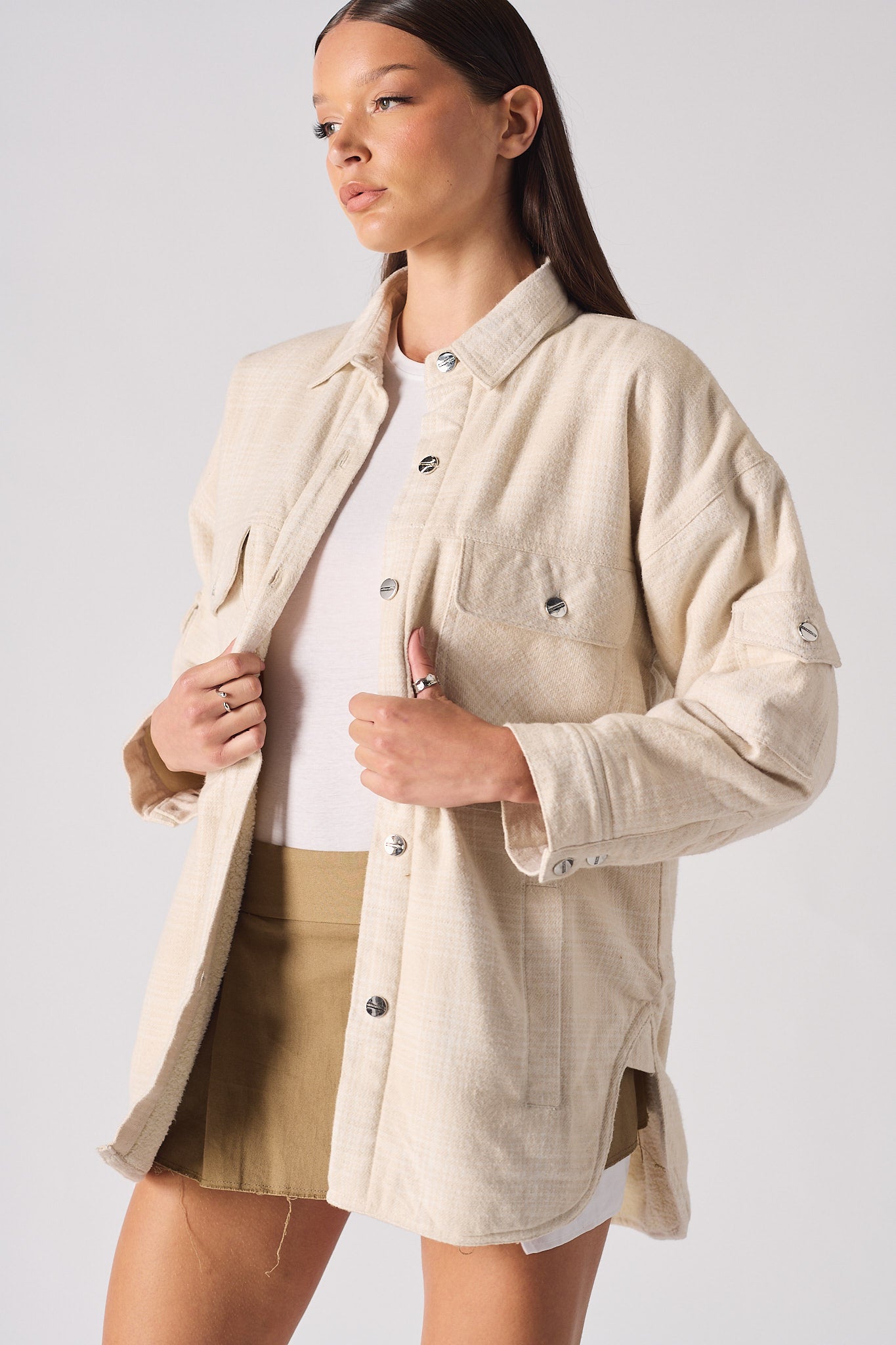 Close-up of a model wearing the women's beige check overshirt.