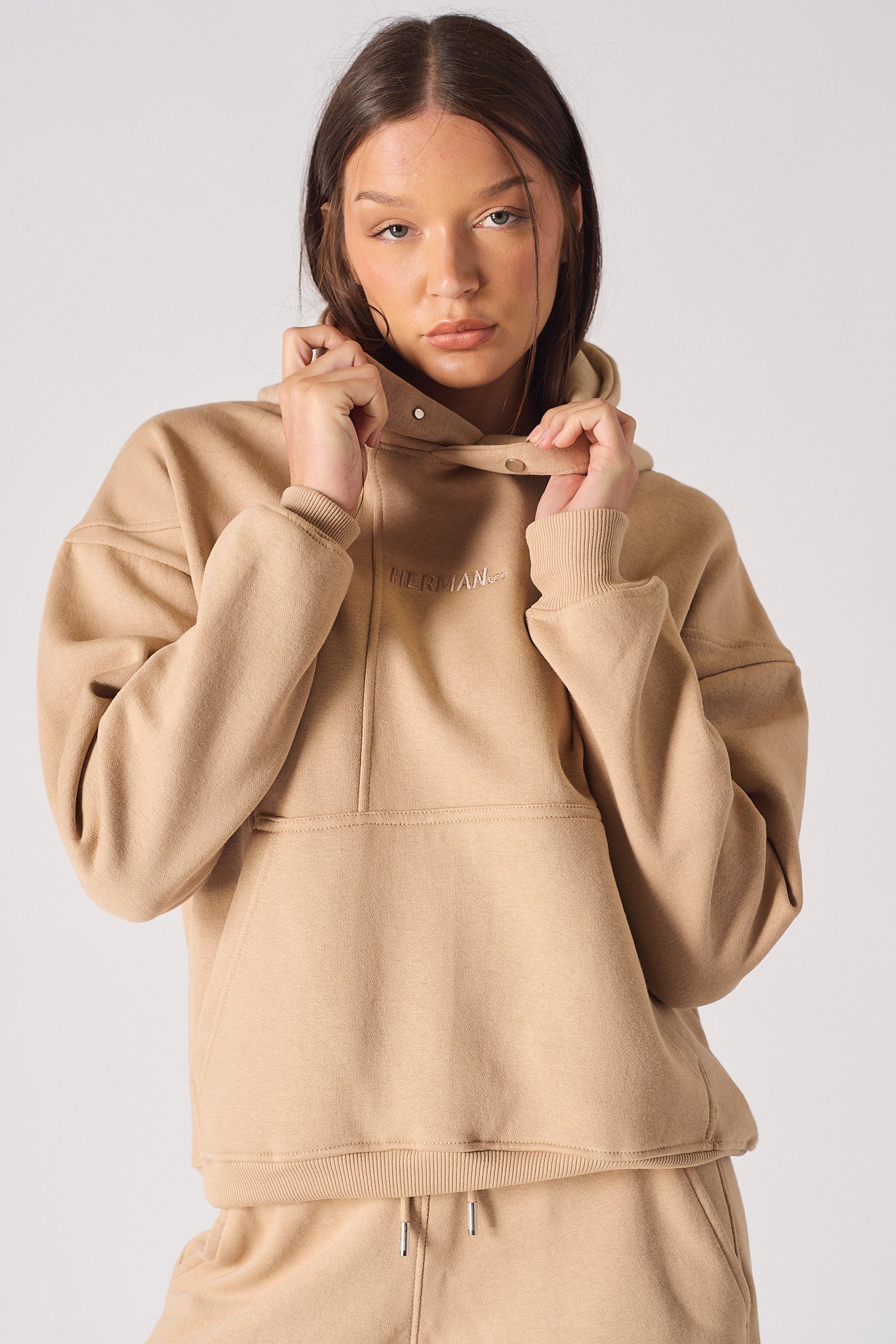 Mid shot of model wearing a stylish beige hoodie womens casual look