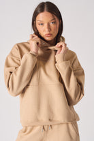 Mid shot of model wearing a stylish beige hoodie womens casual look