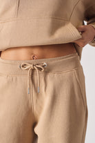 Detailed view of the drawstring waist on the beige joggers for women.