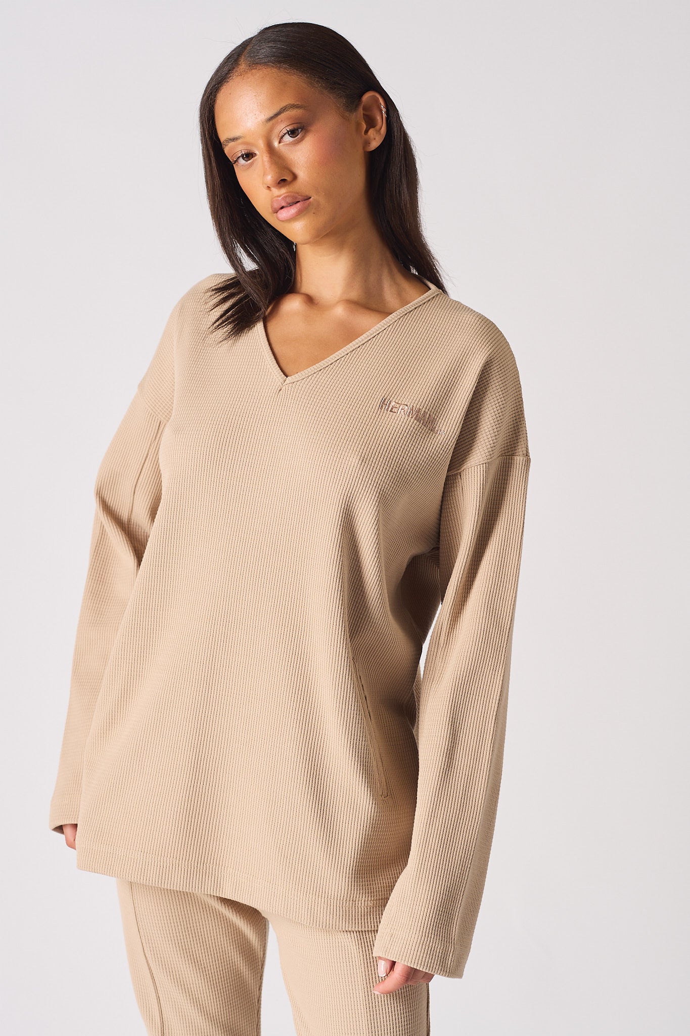 Detailed close up of the tonal logo embroidery on the chest