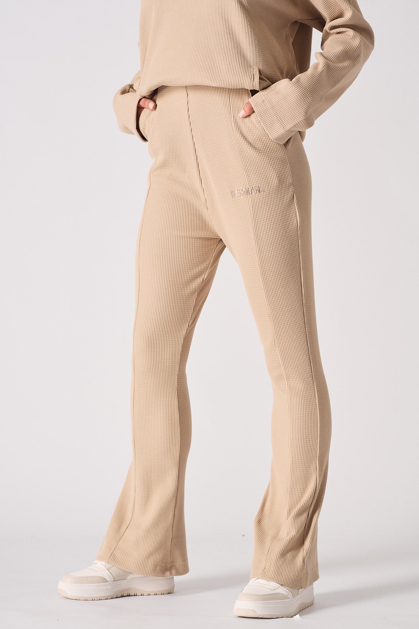 Close-up of the beige waffle joggers with hands in the pockets to show a relaxed fit