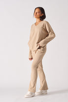 A model styled in the comfortable beige waffle loungewear set with flare joggers