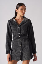 Close-up of the belted acid wash denim dress, focusing on the stitched belt and buttons