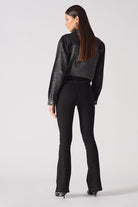 Back view of a model wearing the black high-rise flare jeans.