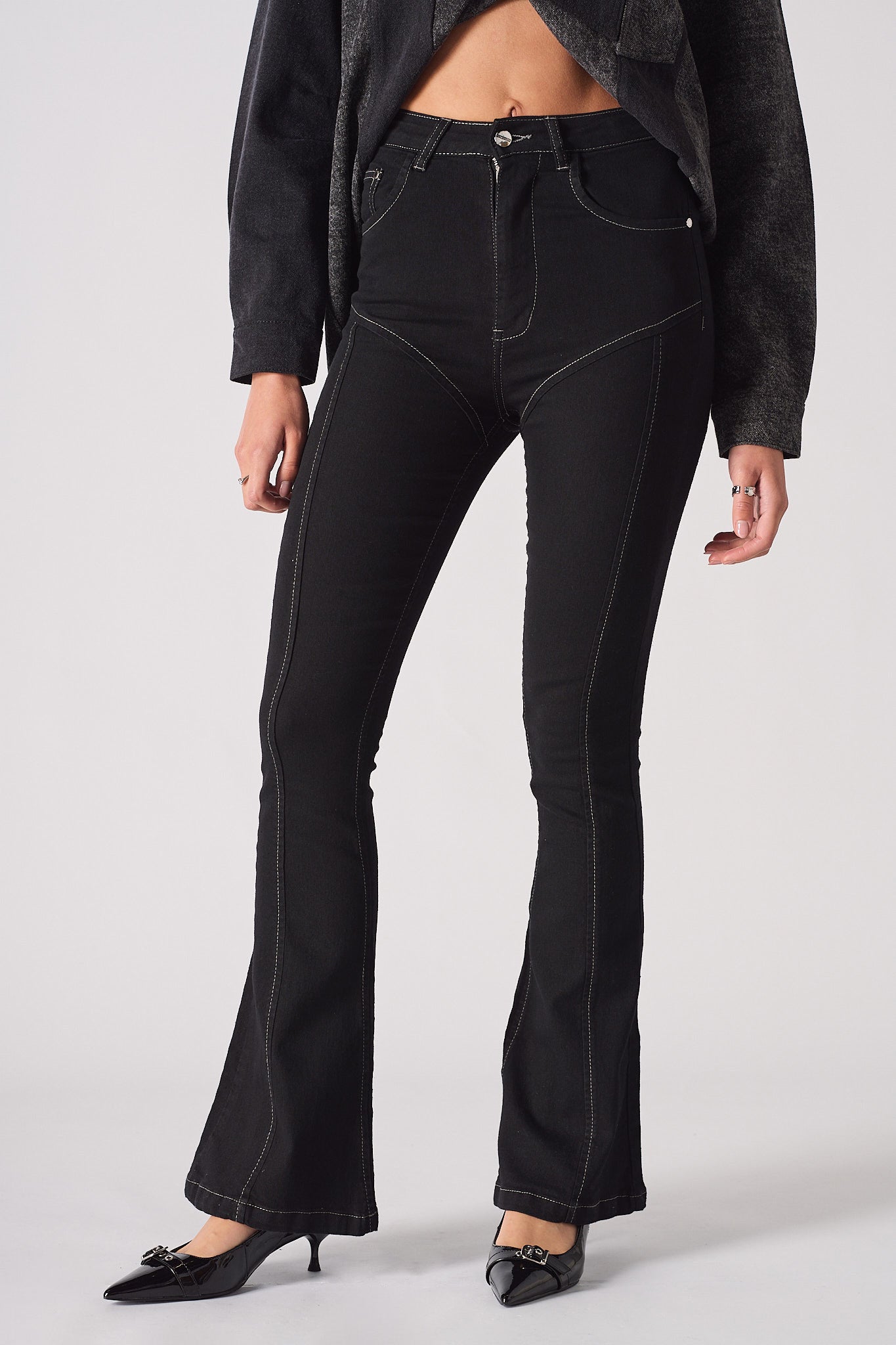Front close-up of the women's black high-rise flare jeans with contrast stitching.