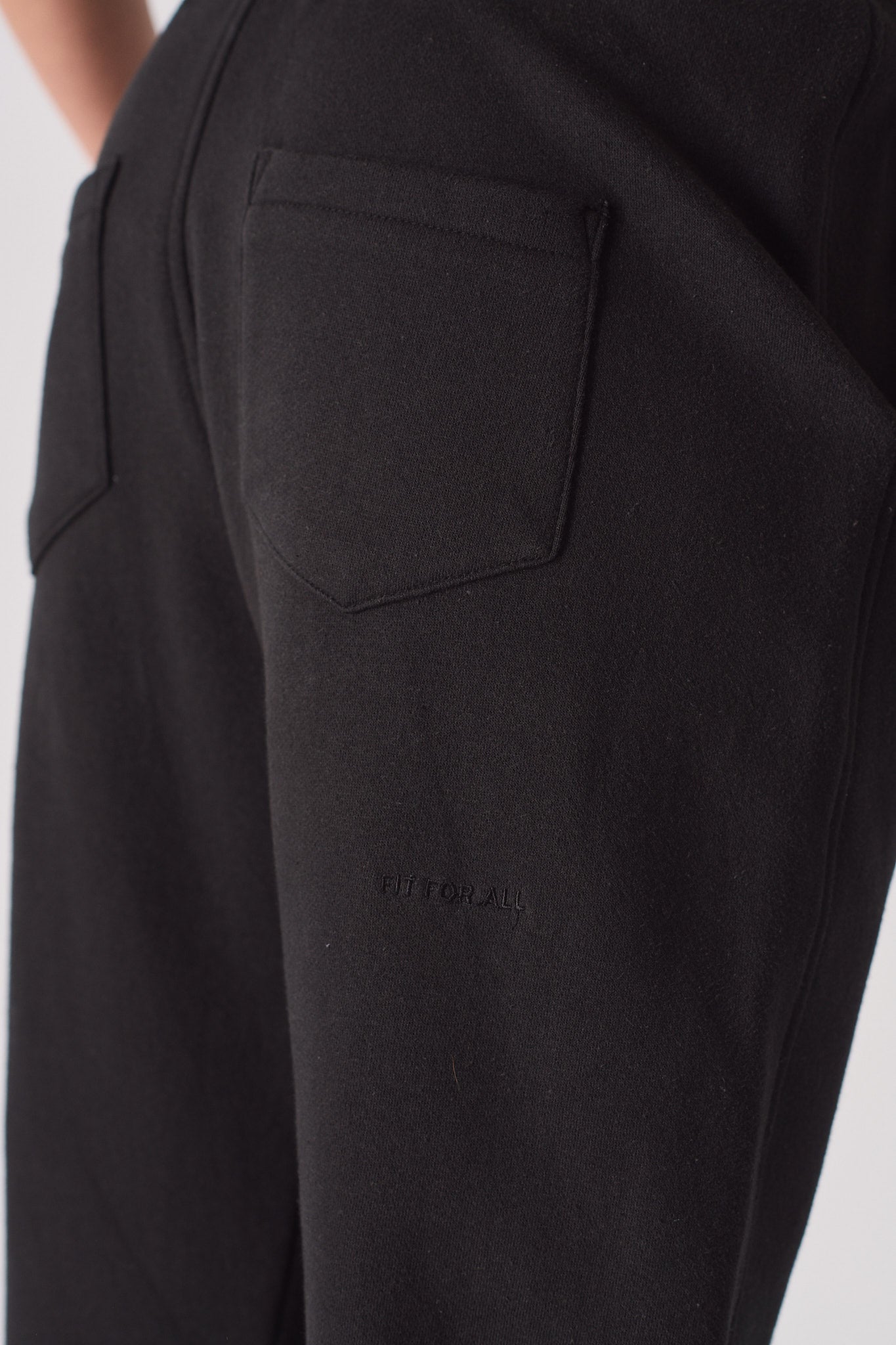'Fit For All' embroidered detail on the back of the black tapered joggers