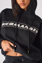 Close up texture view of the soft black fabric and white logo print