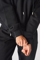 Portrait view of model wearing stylish womens black oversized hoodie