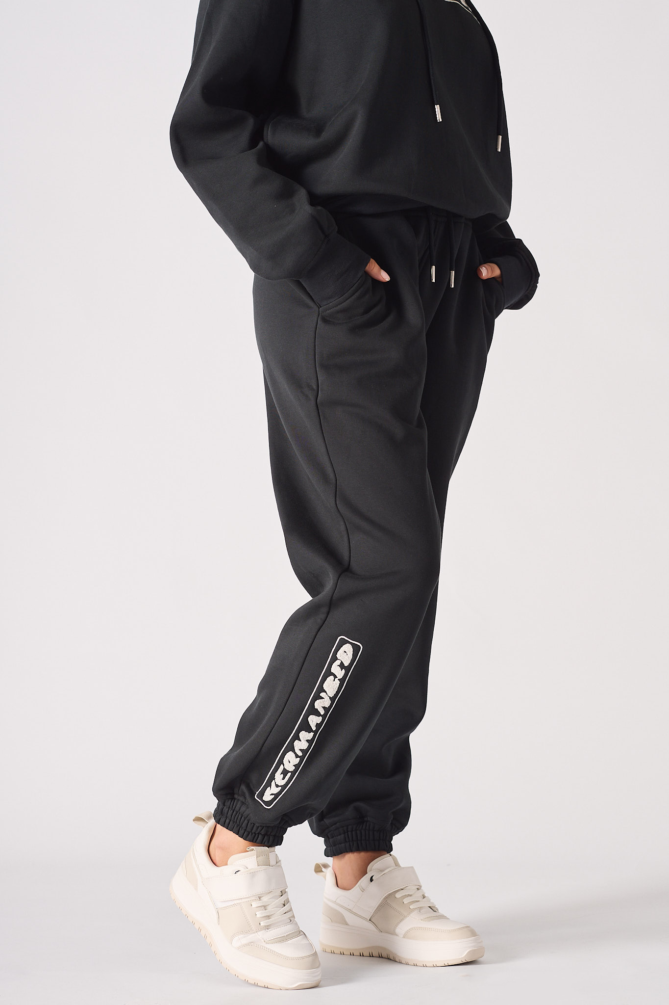 Close up of the side stripe detail and fit on black oversized joggers womens