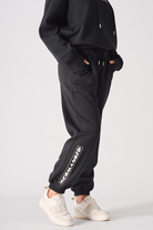 Close up of the side stripe detail and fit on black oversized joggers womens