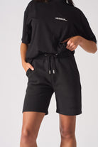 Close up of the elasticated waistband and drawstring on black shorts