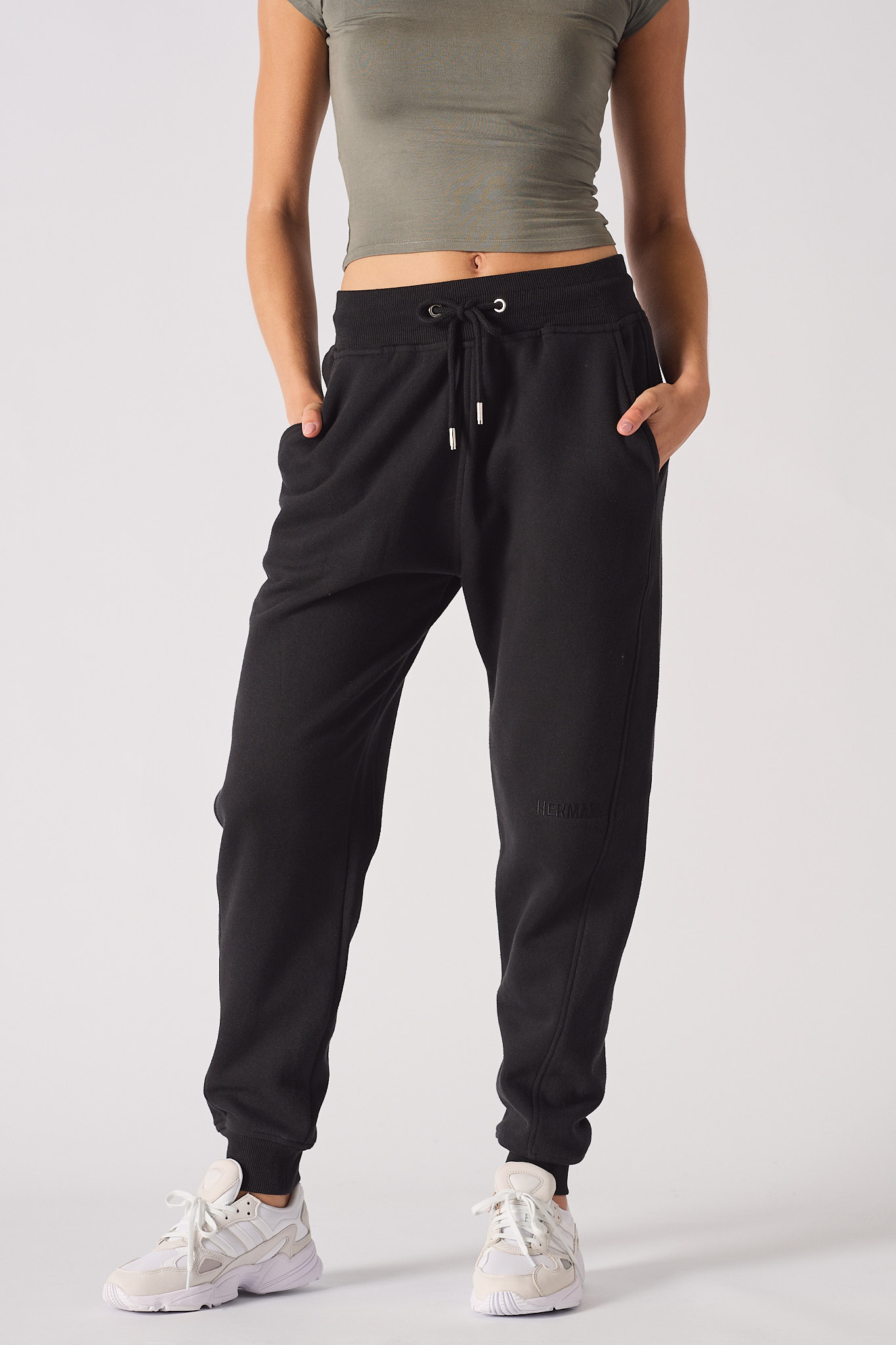 Front view of the black tapered joggers for women, showing the logo and fit.