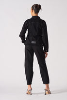 Back view of a model wearing the black tapered waist denim jacket.