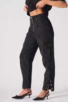 Side view of the black zip front jeans showing the popper hem detail.