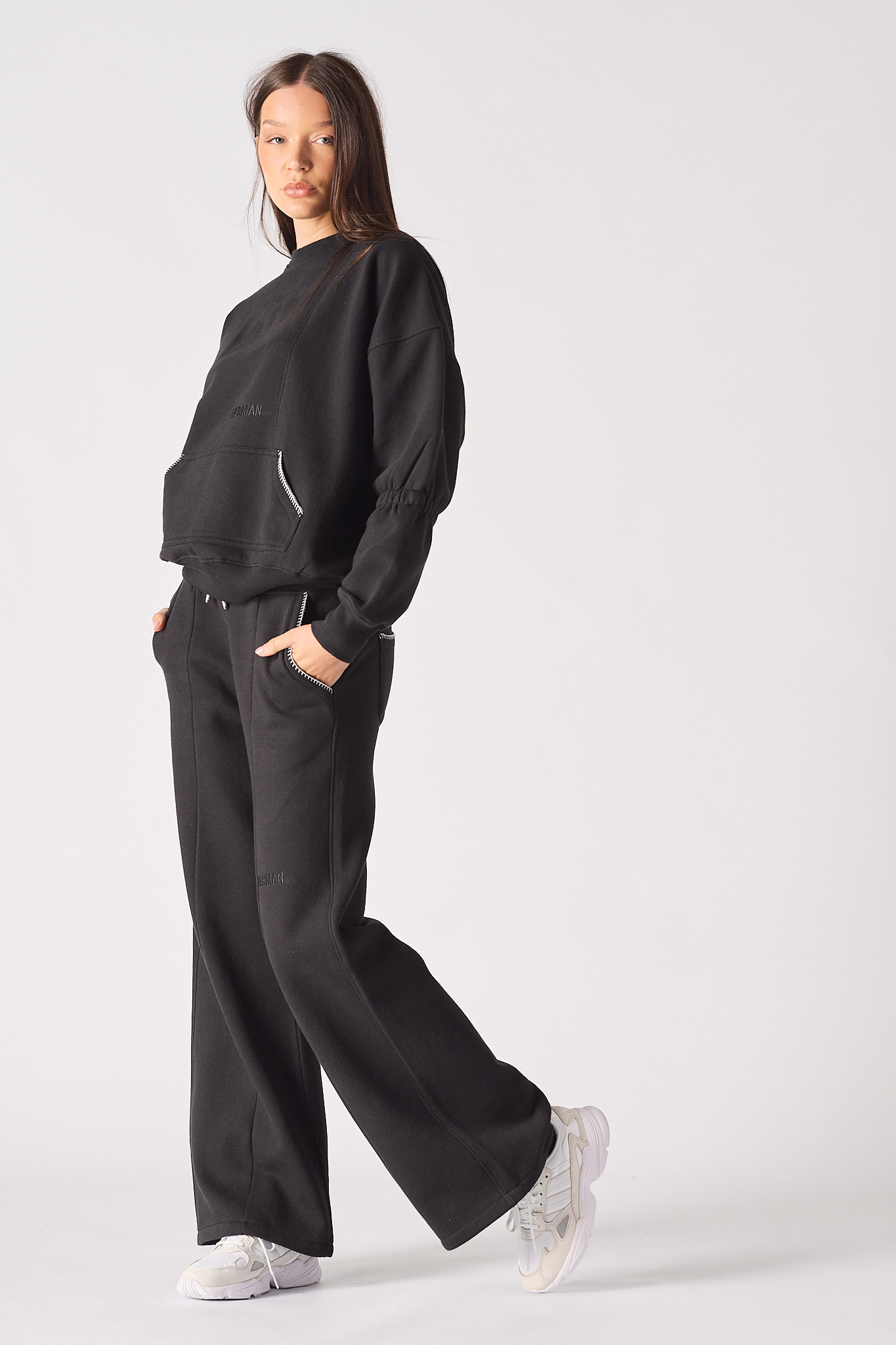 Side profile of a model walking in the women's blanket stitch jumper.