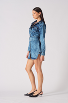 Full side profile of a model in the blue acid wash denim shirt dress