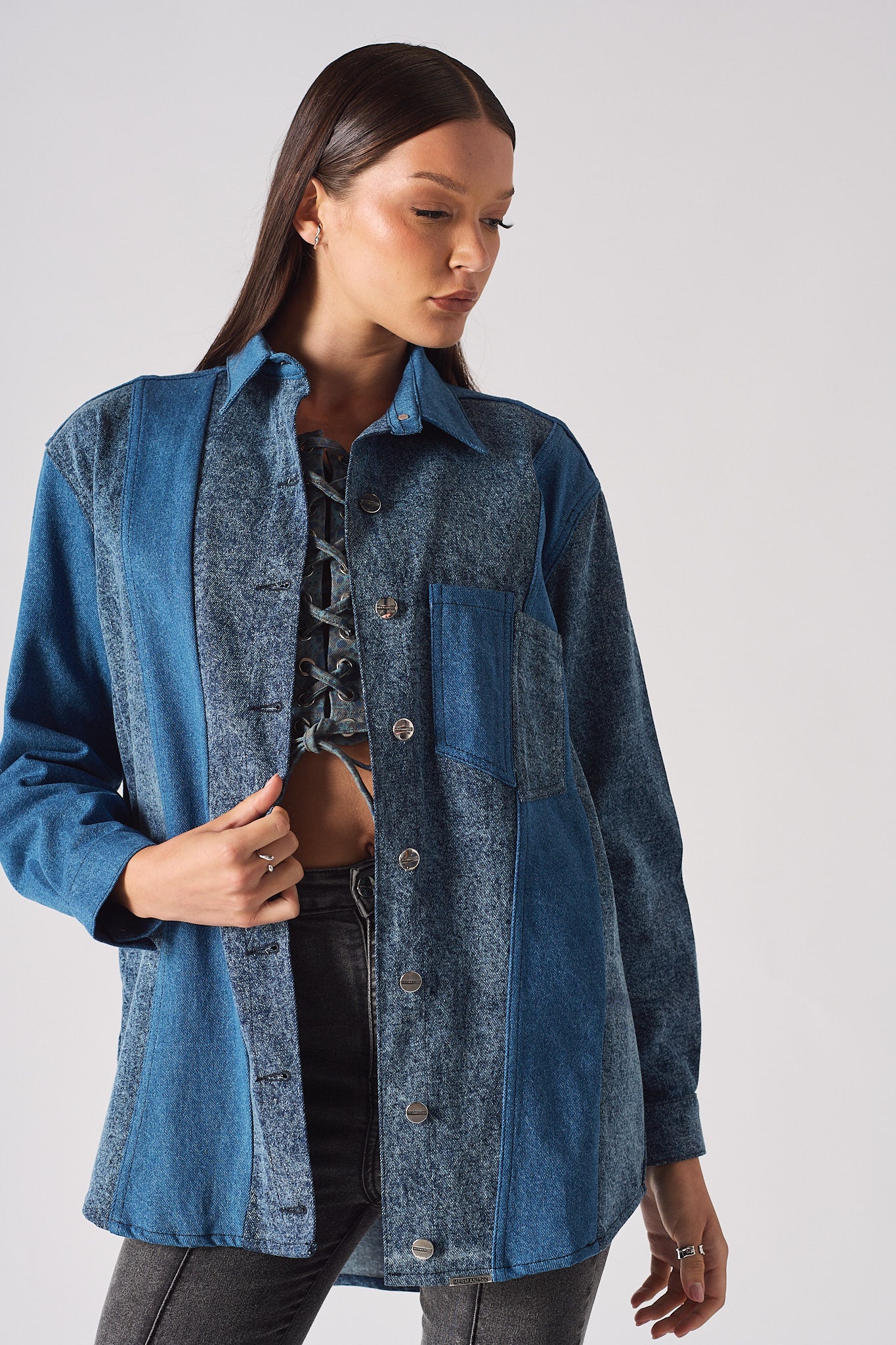 Detailed view of the cuff and collar on the blue acid wash shirt.