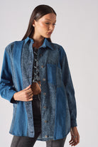 Detailed view of the cuff and collar on the blue acid wash shirt.