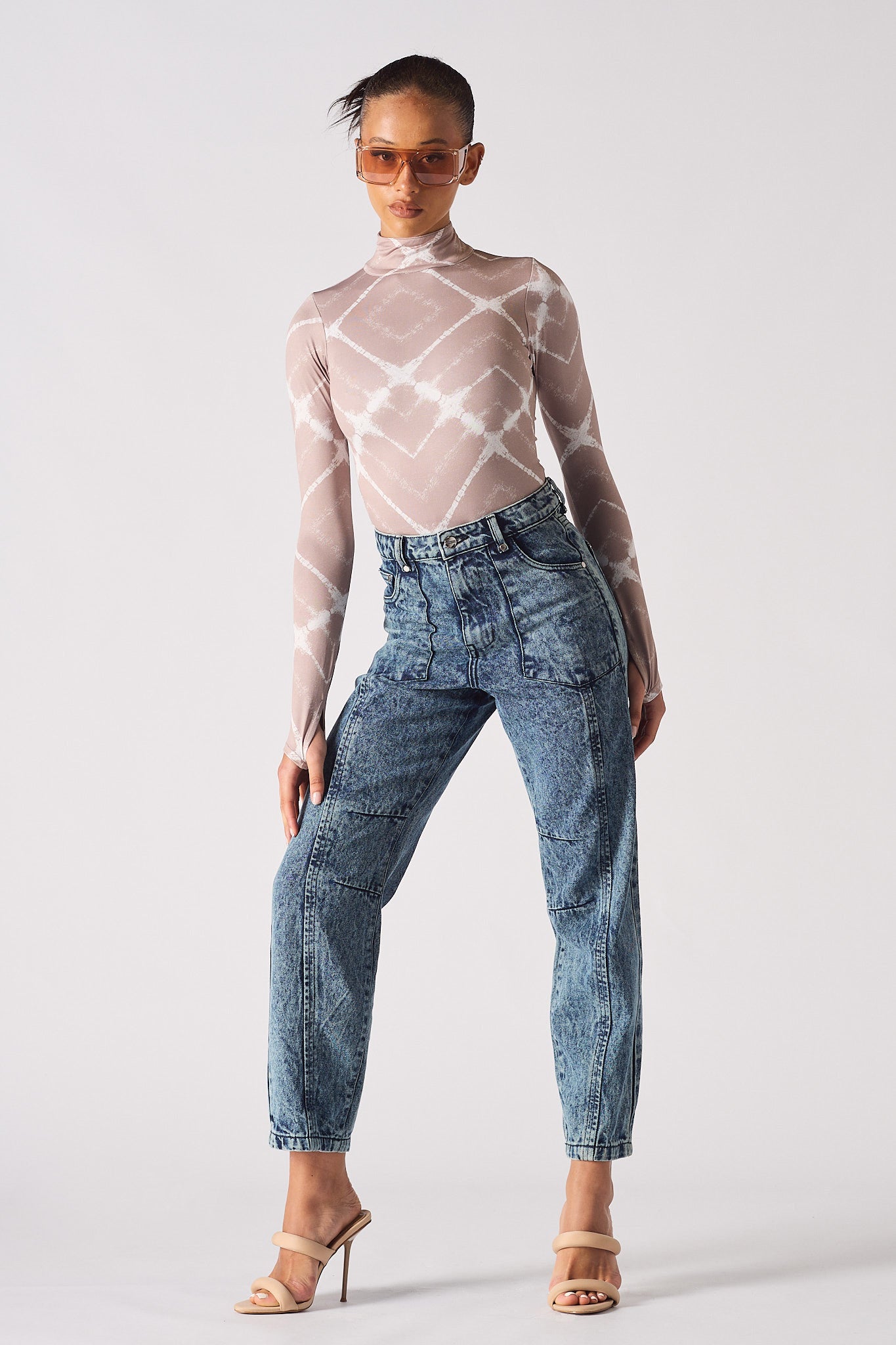A model wearing the blue acid wash straight leg mom jeans.
