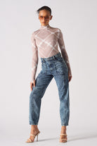 A model wearing the blue acid wash straight leg mom jeans.