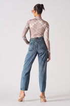 Back view of a model in the blue tapered acid wash mom jeans.