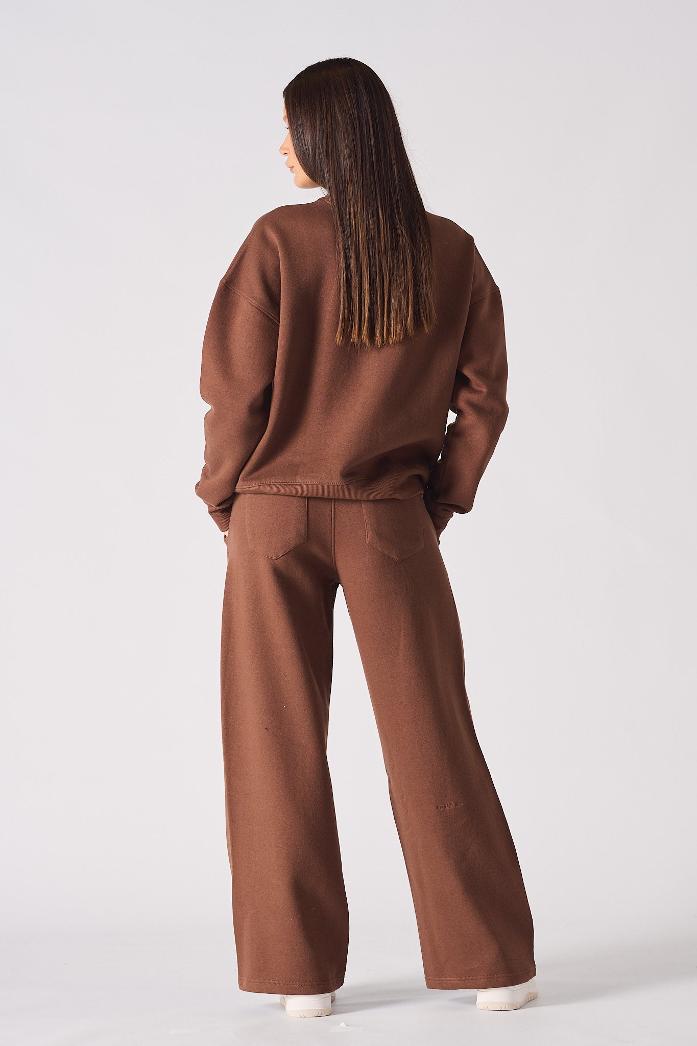 Rear view showing the relaxed fit of the brown crew neck jumper for women