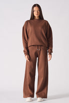 Model standing in a casual brown crew neck jumper womens set