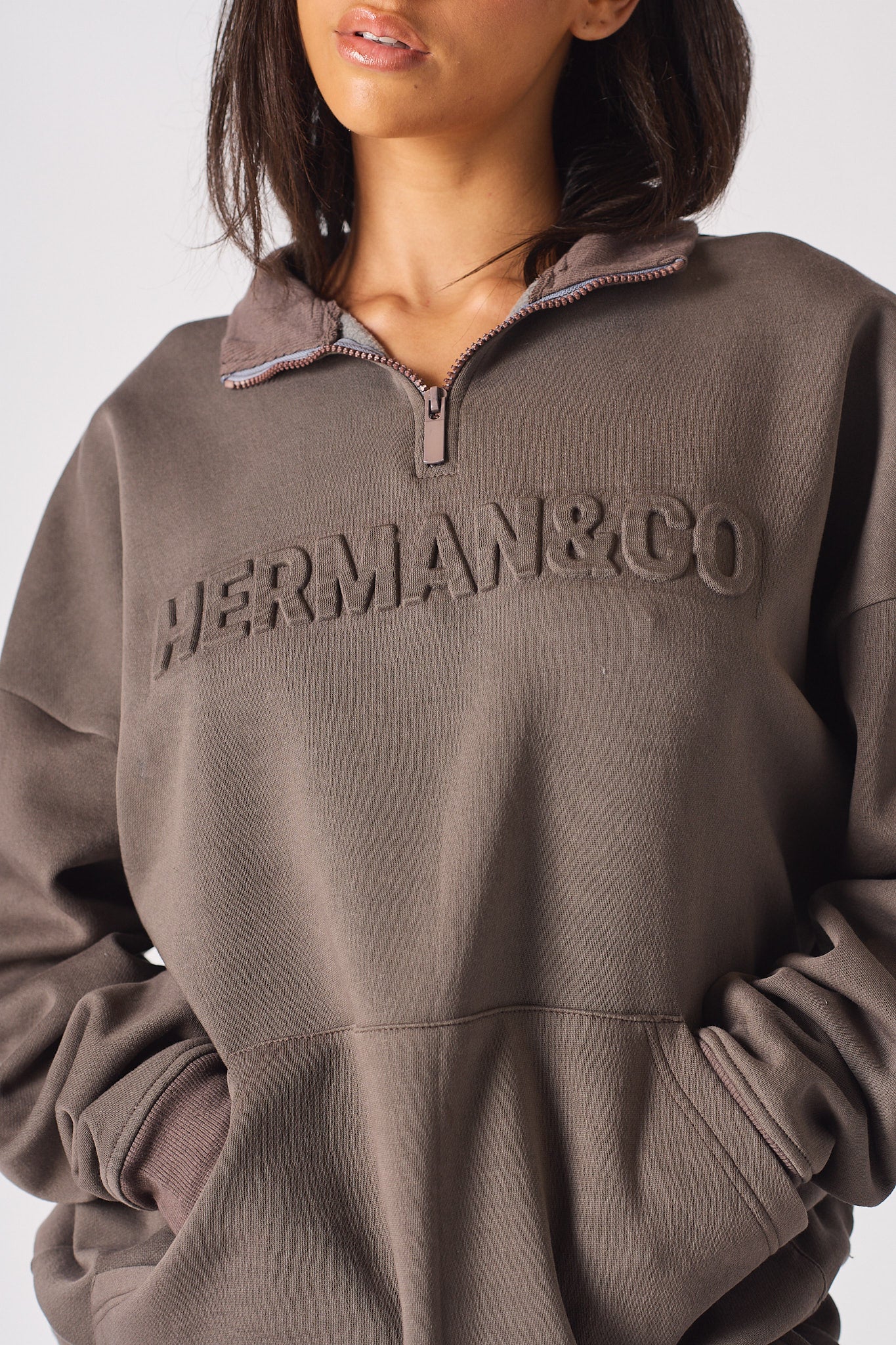 Full length side view of the brown half zip women's sweatshirt and wide leg pants