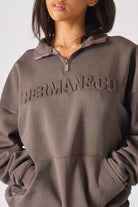 Full length side view of the brown half zip women's sweatshirt and wide leg pants
