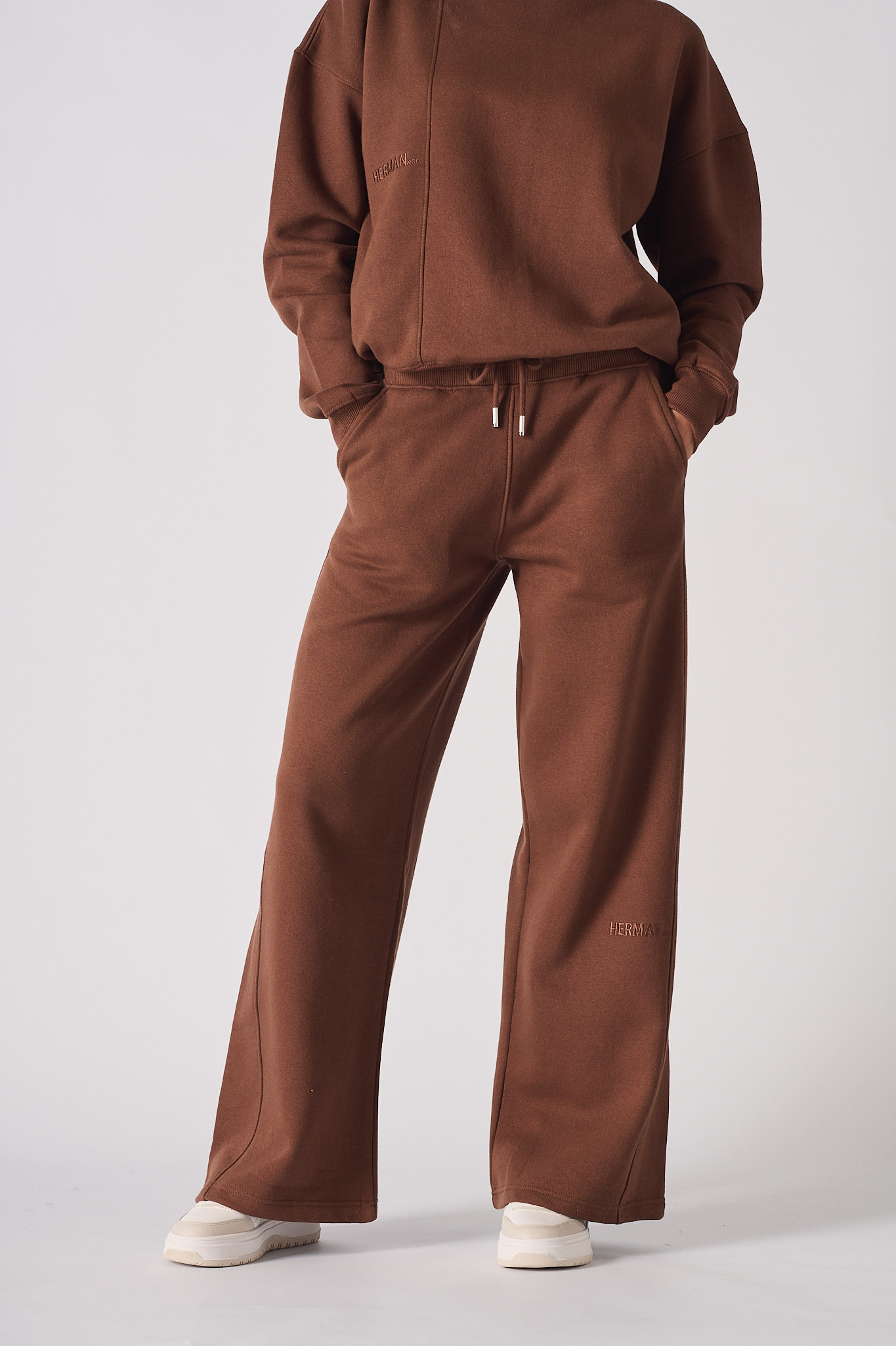 A model styled in the brown joggers for women with a matching sweatshirt.