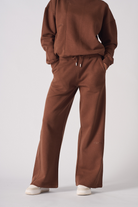 A model styled in the brown joggers for women with a matching sweatshirt.