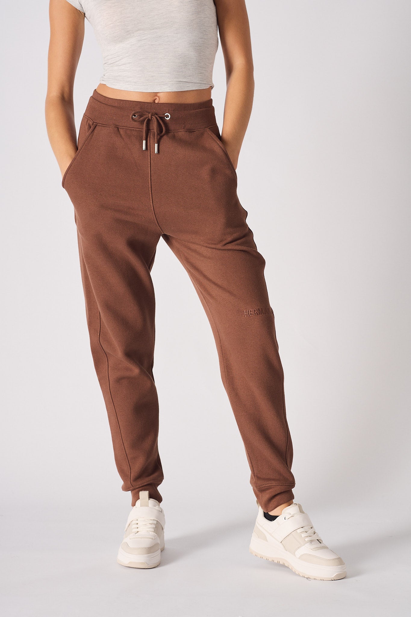 Front view of the brown tapered joggers for women.