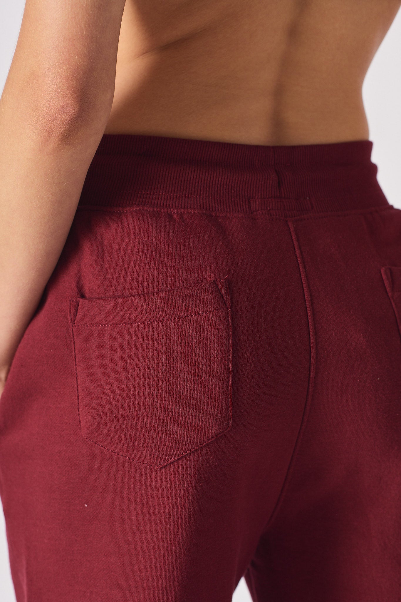 Close up view showing the soft fabric texture of the burgundy joggers